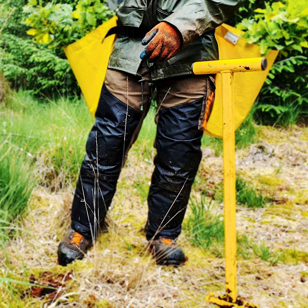 PLANTEM Double Tree Planting Harness with easy to access fabric buckets holding oak tree saplings in woodland