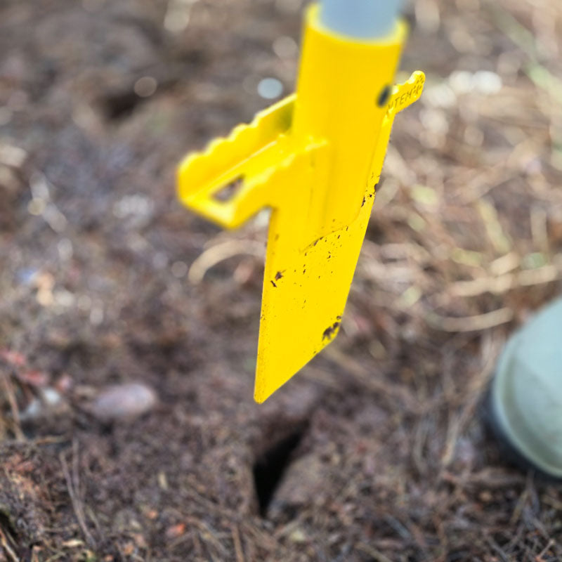 PLANTEM Short Dibber creating a triangular planting pocket for a tree sapling cell