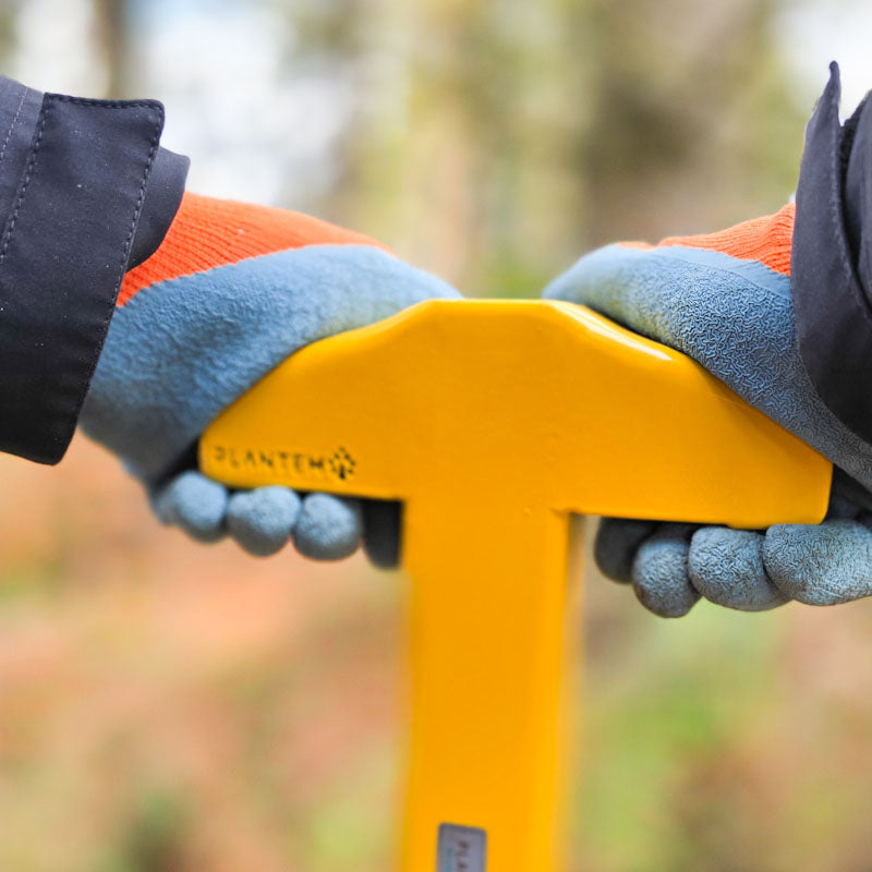 StakeAid being held by both hands with unique angled handle