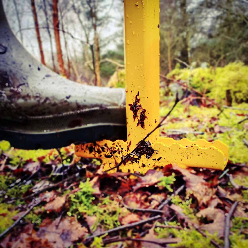 PLANTEM Dibber double sided wide foot rest, creating hole for planting a tree sapling in a woodland